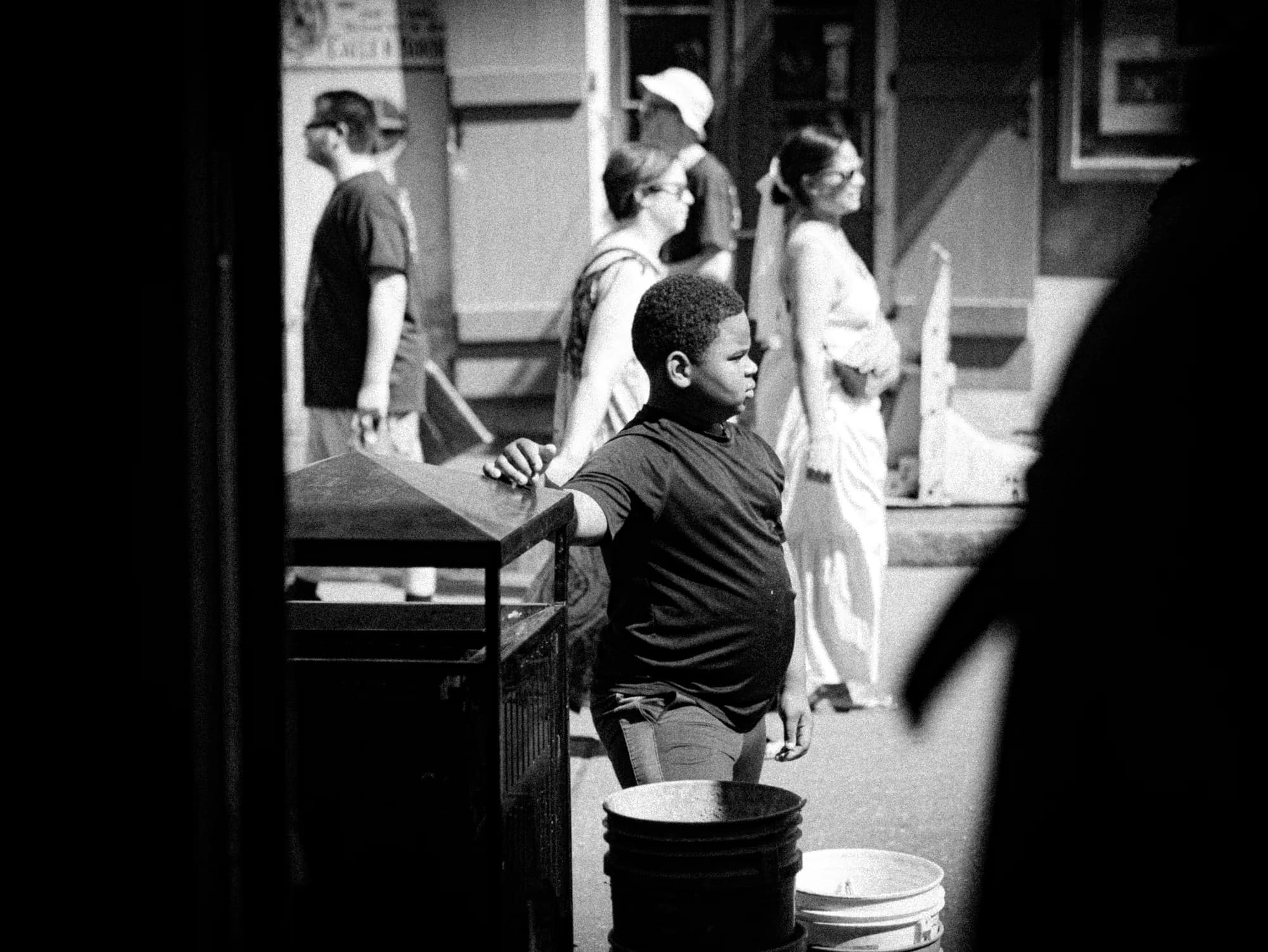 Boy on a busy sidewalk