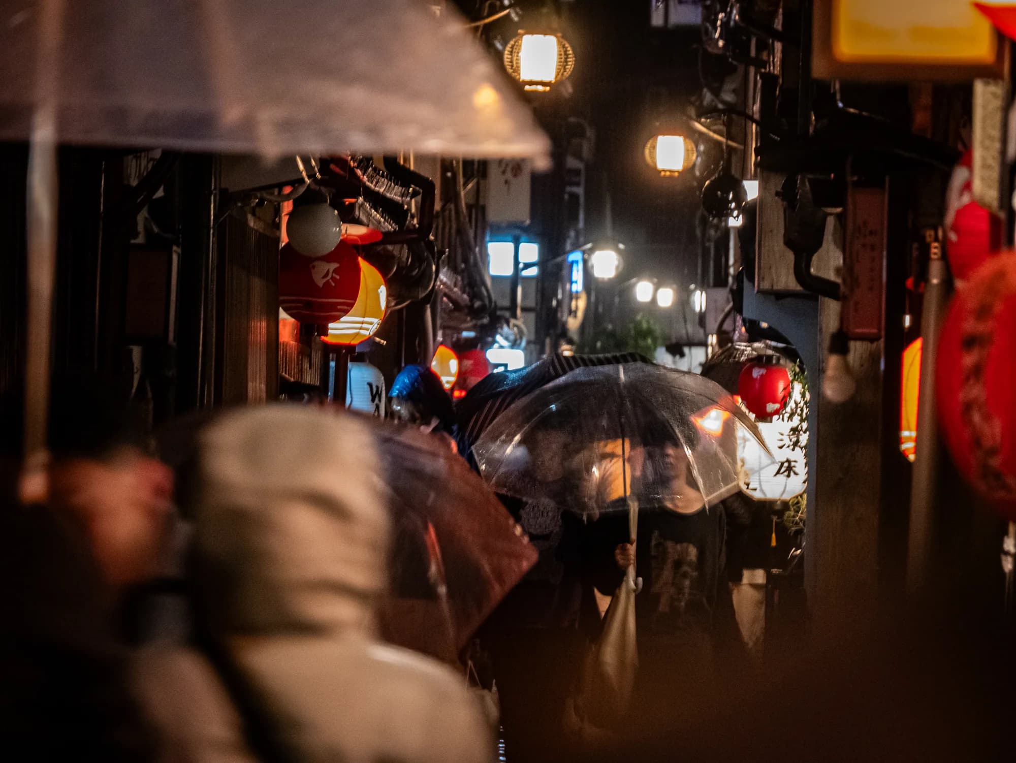 Umbrellas in a lantern lit alley